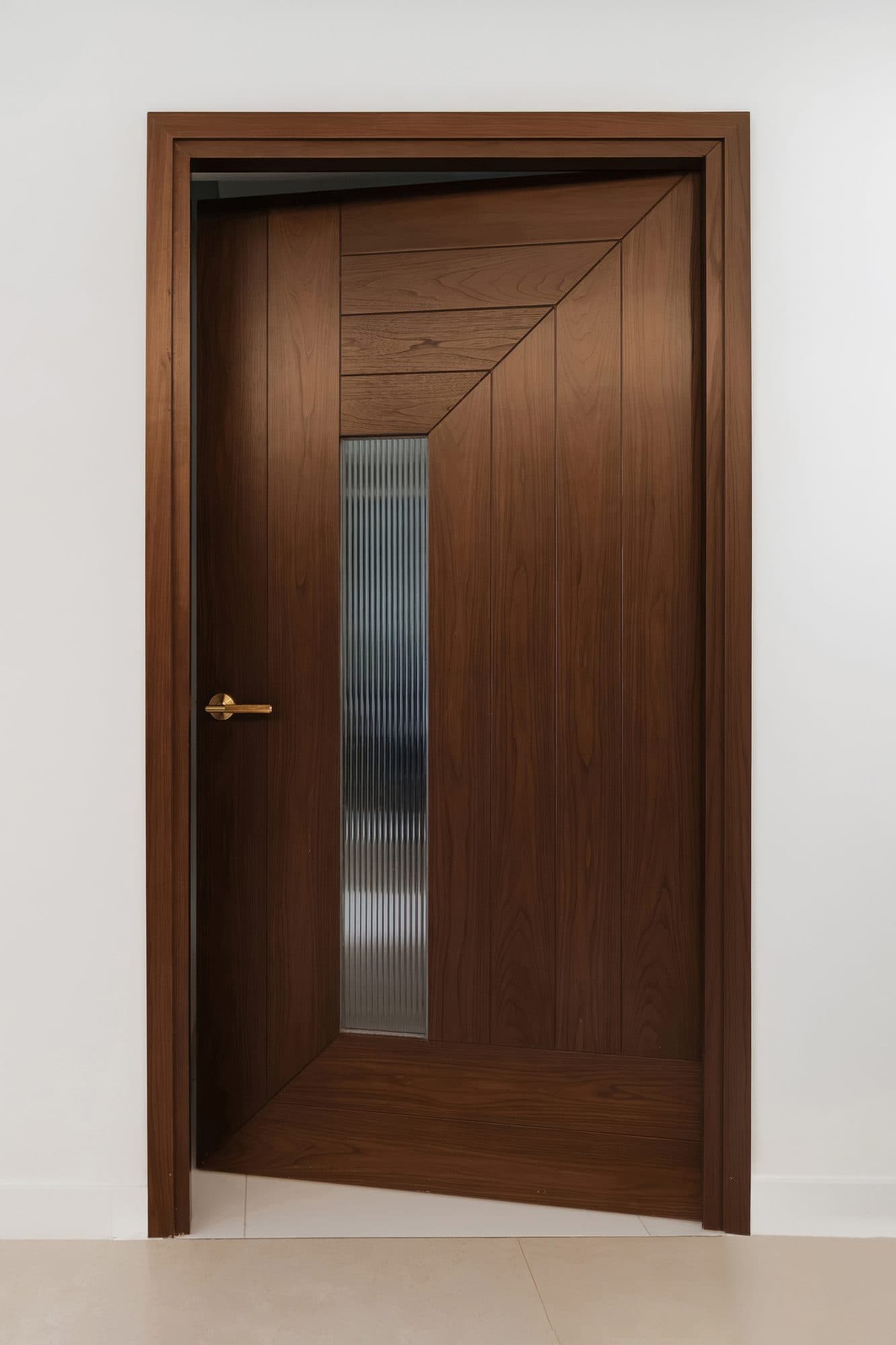 The hallway door as built, in walnut with a mitered plank pattern and a narrow vertical slot of fluted glass