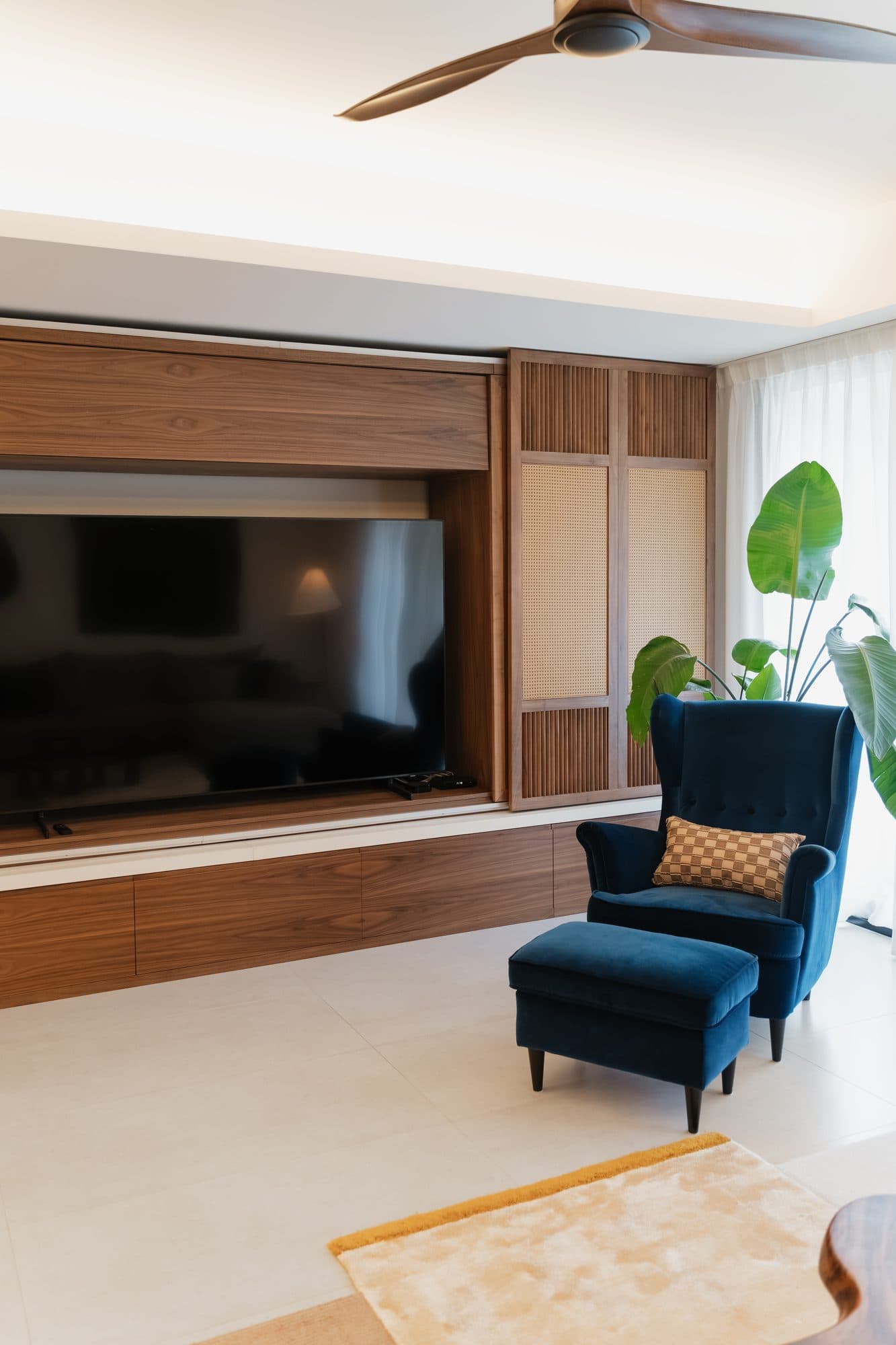 The center panels slid back to reveal a television recessed into a walnut-lined niche